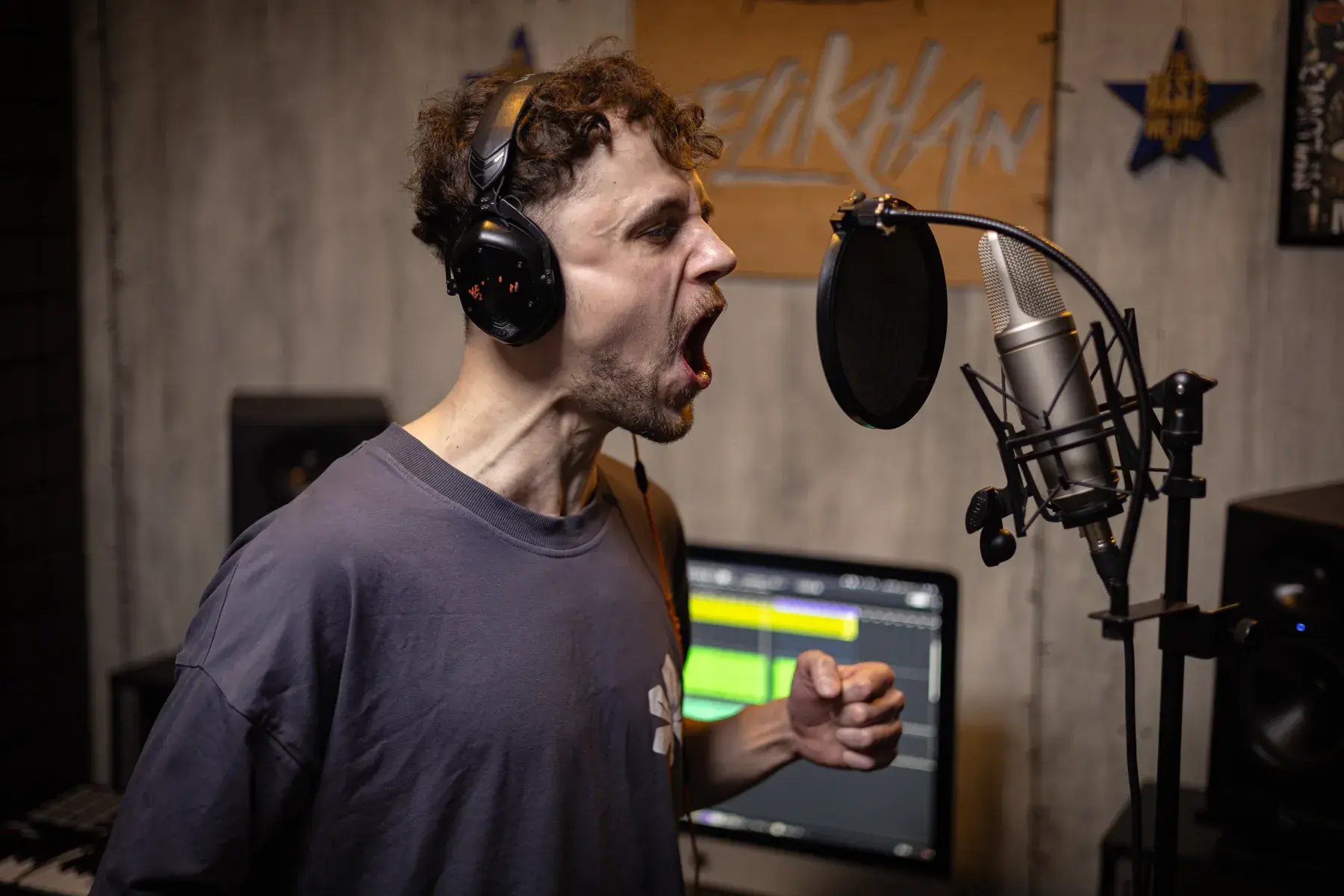 Mykyta Obushenko singing into a studio microphone at Velikhan Music Academy